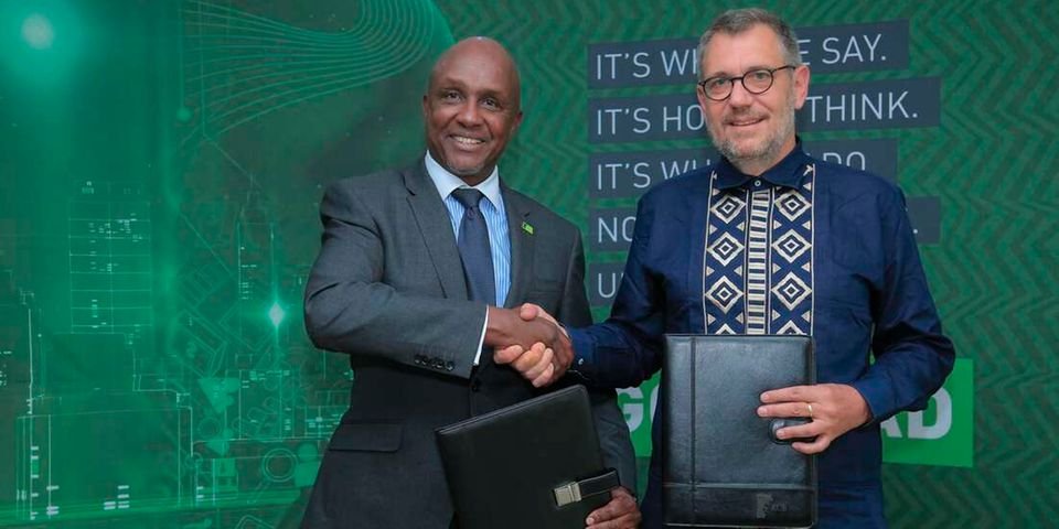 KCB Group PLC Chairman Andrew Wambari Kairu and Oliver Meisenberg, the Chief Executive Officer Trust Merchant Bank (TMB) exchanging documents on August 2, 2022 during a ceremony where KCB signed a definitive agreement to acquire a majority stake at Trust Merchant Bank. TMB is the third largest lender in DRC. 
